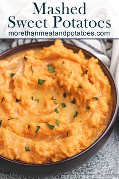 mashed sweet potatoes in a black bowl with parsley on top and text overlay