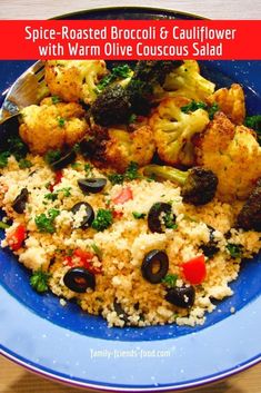 a blue plate topped with rice, broccoli and cauliflower covered in olives