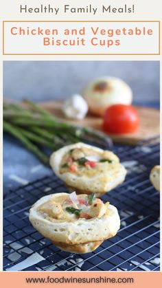 chicken and vegetable biscuit cups on a cooling rack with tomatoes, asparagus and onions in the background