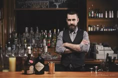 a man standing at the bar with his arms crossed