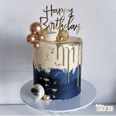 a birthday cake decorated with gold and blue icing