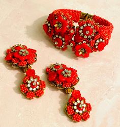 "Beautiful Signed Stanley Hagler NYC clamper bracelet and matching Dangle earrings. This is sooo Hagler, I call this High Hagler. Most Likely from 80's or 90's Luxurious beautiful red coral glass flowers with crystal chatons and beads. Clamper Bracelet measures 2 1/8 \" X 1 7/8 inches so really a small medium, but as it is a clamper could be worn by larger wrist. Bracelet has strong hinge. This set is in great Vintage condition. Gold gilt on filigree is very good. Earrings are a perfect match as Good Earrings, Vintage Beaded Bracelet, Wrist Bracelet, Vintage Bakelite, Glass Flowers, Red Coral, Vintage Jewellery, Etsy Items, Designer Earrings