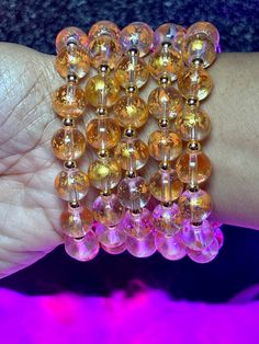 Royal Arm Candy Individual Bracelets feature 8mm or 10mm beads, making it the ideal accessory to adorn your arm and amplify its allure. What do you get: 1 bracelet Fits a 7" wrist but can stretch bigger 10mm beads Orange Beaded Bracelets With 8mm Round Beads, Gold Stretch Bracelet With 108 Round Beads, Gold Stretch Bracelet With 8mm Beads For Party, Elegant Amber Beaded Bracelets With 8mm Beads, Gold Crystal Bracelet With 108 Round Beads, Spiritual Round Beads Bracelets For Party, Spiritual Round Beads Bracelet For Party, Spiritual Round Bead Bracelets For Parties, Gold Crystal Bracelet With 8mm Beads For Party