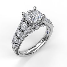 a diamond ring with two rows of diamonds on the band and an oval shaped center stone