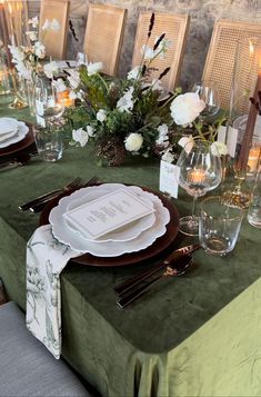 the table is set with place settings for dinner