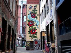 an alleyway with graffiti on the side of buildings