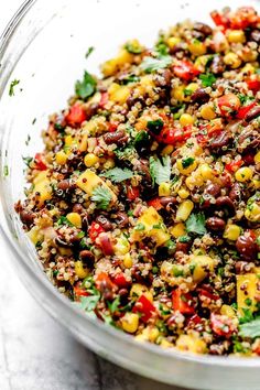 a bowl filled with lots of food on top of a table