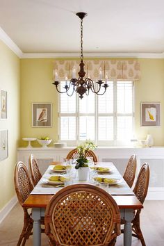 a dinning room table with chairs and a chandelier hanging from the ceiling