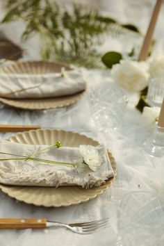 the table is set with plates and silverware