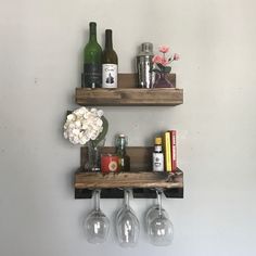 two wooden shelves holding wine glasses and bottles