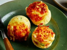 three small food items on a green plate