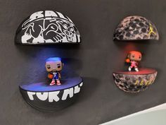 three shelves with various items on them in the shape of basketballs and pop figures