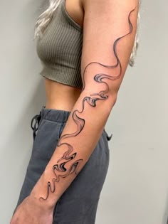 a woman with a tattoo on her arm