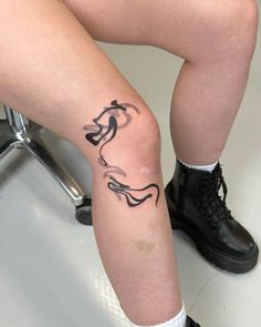 a person with a tattoo on their leg