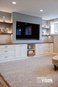 a living room filled with furniture and a flat screen tv mounted above the entertainment center