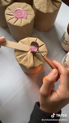 a person is using a spoon to decorate some cupcakes