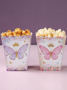 two butterfly shaped boxes filled with popcorn