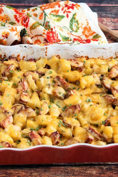 a casserole dish filled with macaroni and cheese on a wooden table