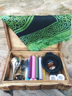 an open wooden box filled with assorted items