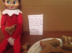 an elf is sitting next to some cookies and a note that says it's christmas