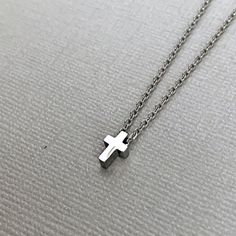 Dainty cross necklace is lightweight and perfect for everyday wear! A tiny, chunky stainless steel cross charm hangs from a fine stainless steel chain, which fastens with lobster clasp. Necklace is available in 3 lengths. Stainless steel will not tarnish, and is a great alternative for those with a sensitivity to metal! All items are carefully wrapped and packaged. In order to remain environmentally friendly, I only include a box when requested. Gift wrap is also available to purchase, and your Minimalist Stainless Steel Cross Necklace With Adjustable Chain, Gift White Gold Cross Necklace In Stainless Steel, Minimalist Stainless Steel Cross Necklace As A Gift, Minimalist Stainless Steel Cross Necklace For Gift, Minimalist Silver Stainless Steel Cross Necklace, Minimalist Stainless Steel Cross Pendant Necklace, Hypoallergenic Stainless Steel Cross Jewelry, Stainless Steel Cross Necklace Tarnish Resistant, Tarnish Resistant Stainless Steel Cross Necklace