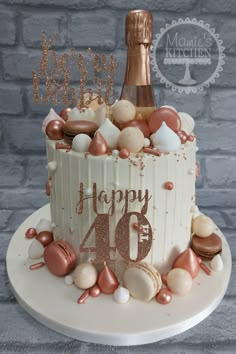 a birthday cake decorated with seashells and a bottle of champagne for a 40 year old