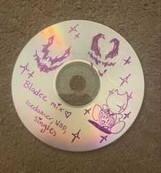 a cd with writing on it sitting on the floor