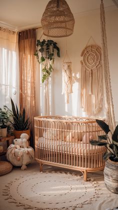 a baby crib in the corner of a room with potted plants on the floor