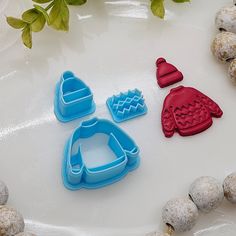 three cookie cutters sitting on top of a table next to some doughnuts