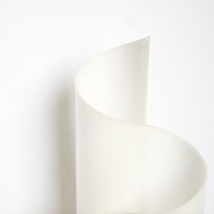 a white vase sitting on top of a table