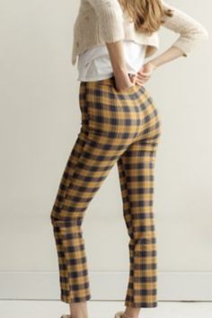 High-waisted pant from Urban Outfitters topped with an allover plaid finish. Notched at the hem and topped with a button closure at the zipper fly. Content + Care - 35% Polyester, 6% rayon, 5% spandex - Machine wash Casual Plaid Bottoms With Elastic Waistband, Casual Gingham Trousers, Plaid Trousers For Spring, Stretch Plaid Bottoms For Fall, Plaid Straight Leg Bottoms For Spring, Casual Plaid Bottoms For Spring, Chic Fitted Plaid Bottoms, Trendy Fitted Plaid Bottoms, Casual Plaid Pants For Fall