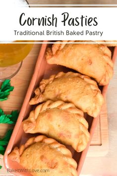 some pastries are on a tray next to a glass of beer and green leaves