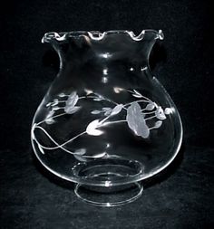 a clear glass vase sitting on top of a black table