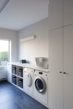 a washer and dryer in a white laundry room