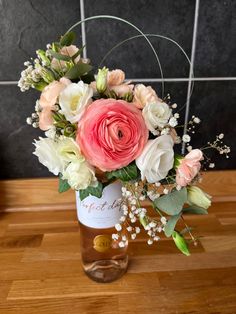 a vase filled with flowers on top of a wooden table