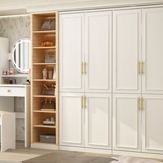 a bedroom with white closets and a desk in the corner, next to a bed