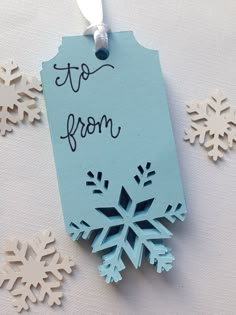 snowflakes and tags with the words to from written on them