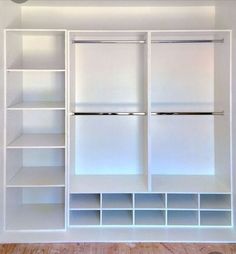 an empty white closet with shelves and drawers