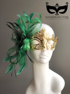 This elegant gold Mardi Gras mask features intricate metal detailing and a vibrant green feather arrangement on the side, making it the perfect accessory for Mardi Gras, masquerade balls, and costume parties. The ornate gold filigree design is accented with rhinestones, adding a touch of glamour and sophistication. The lush green feathers create a striking contrast, ensuring you stand out at any event. Age Group/Gender - Adult/Women Size/Type - One size fits all adults Mask Color - Green/Gold Ma Mardi Gras Kid, Kids Party Packs, Feather Arrangements, Masquerade Ball Masks, Gold Masquerade Mask, Mardi Gras Masquerade, Green Feathers, Metal Mask, Ball Mask