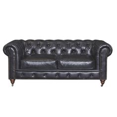 a black leather couch with buttons on the armrests and nail polishing around the arms