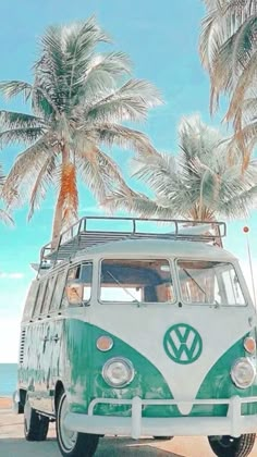 a vw bus parked on the beach with palm trees