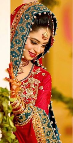 a woman in a red and blue bridal outfit