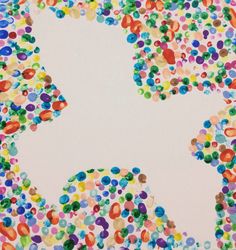 an image of a cat made out of confetti on white paper with colored dots