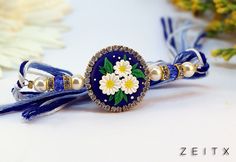 a blue and white bracelet with flowers on it