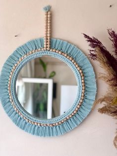 a round mirror hanging on the wall