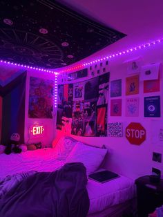 a bedroom with purple lights and pictures on the wall