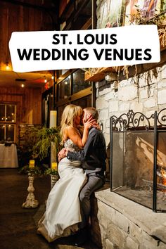 a bride and groom kissing in front of a fireplace with the words st louis wedding venues over it