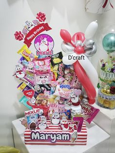 a bunch of balloons and some stickers on a white box with the words d'craft in it