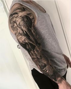 a man with an elephant and zebra tattoo on his arm