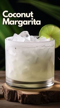 a close up of a drink in a glass on top of a wooden table with the words coconut margarita above it